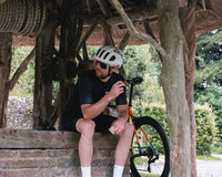 A cyclist eating a Luchos to refuel
