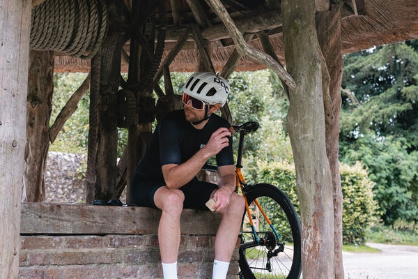 A cyclist eating a Luchos to refuel 