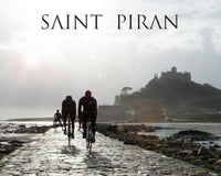 Saint Piran logo with 3 cyclists cycling away from view along a wet path