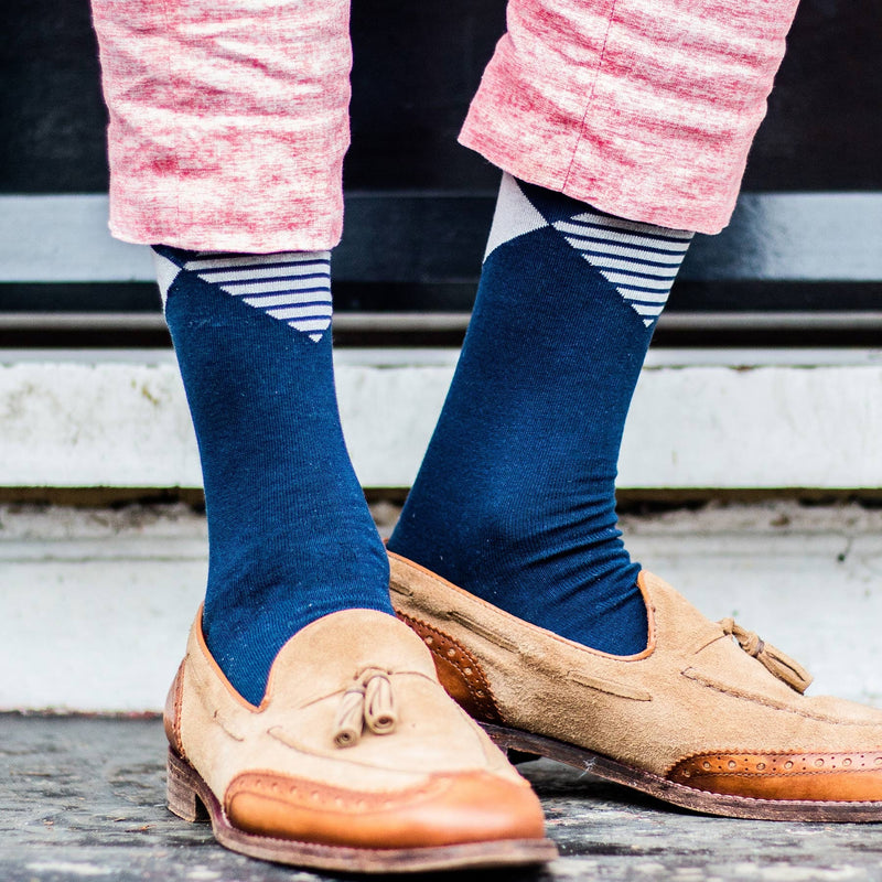Man wearing Navy Big Diamond socks, pink trousers and leather loafer shoes.