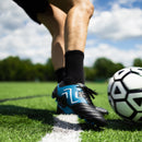 IDA Classica 22 Women's Soccer Cleat, Black and Blue, FG/AG, Firm Ground, Artificial Ground, Player kicking a soccer ball on a turf field