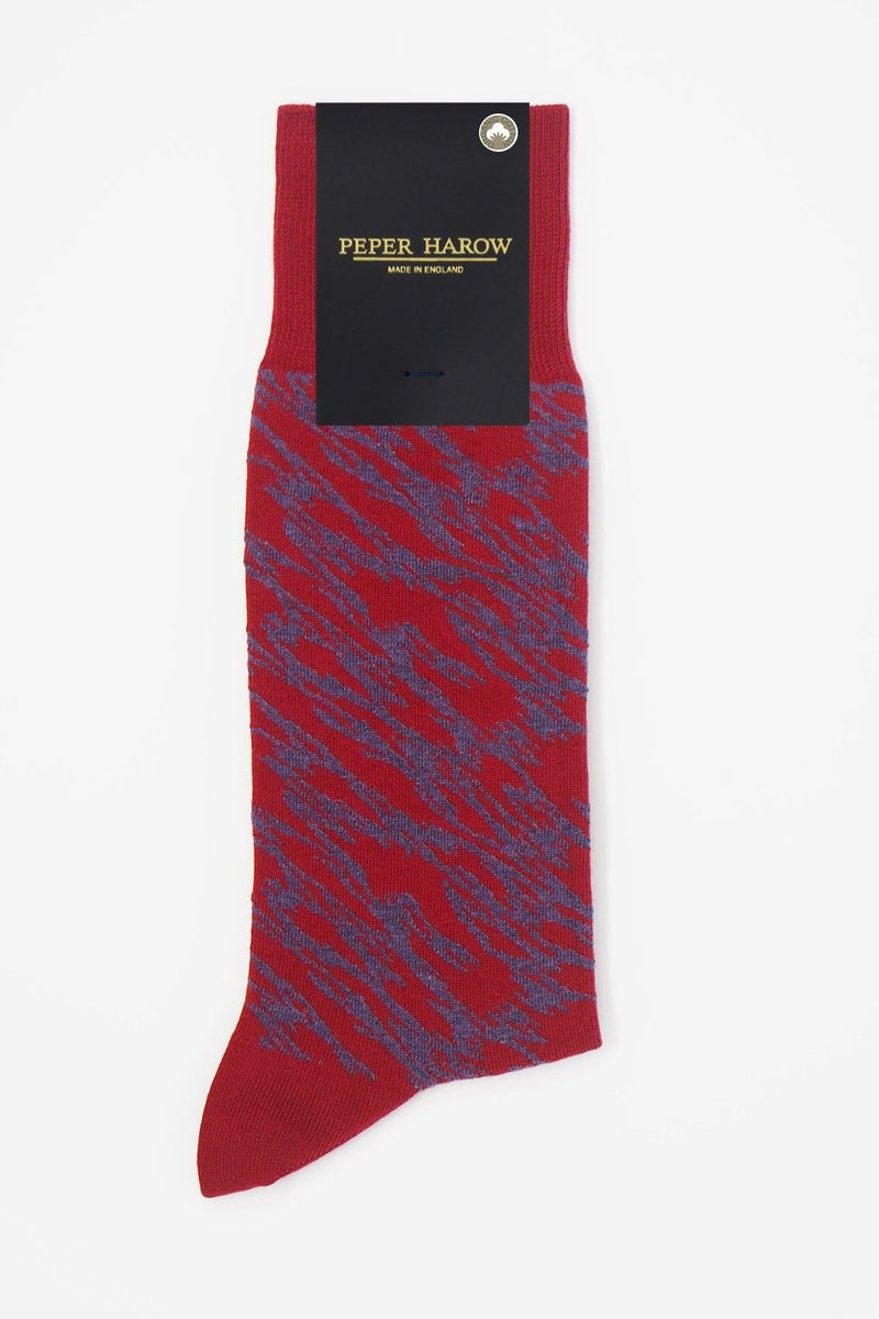 Pandemonium red men's luxury socks by Peper Harow, featuring a quirky purple pattern and purple toe and heel in packaging.