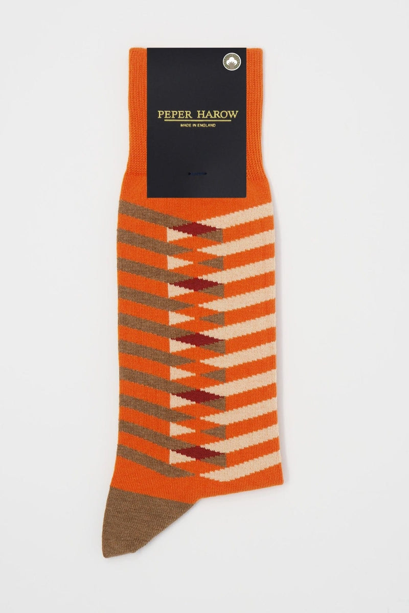 Symmetry orange men's luxury socks by Peper Harow, featuring stylish brown and white stripes, and a brown heel and toe in packaging.