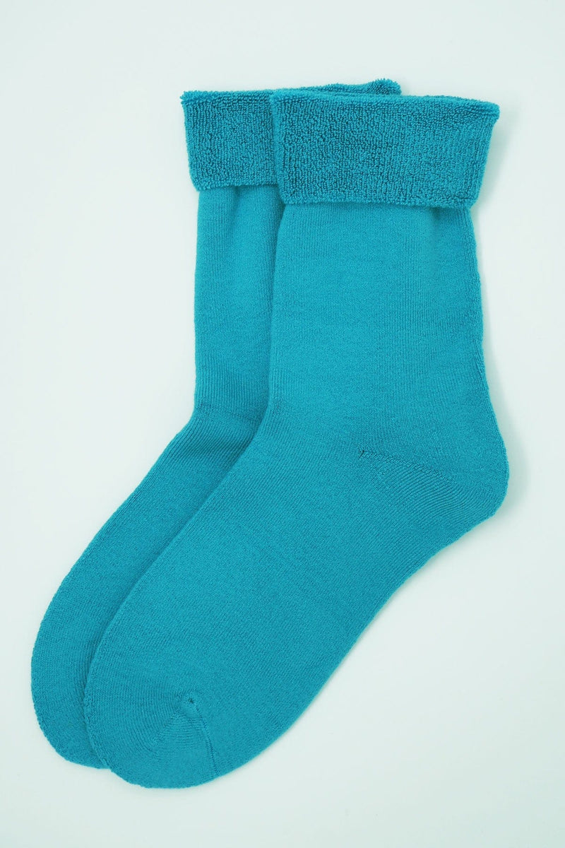 Two pairs of Peper Harow women's bright aqua Plain luxury bed socks showing fluffy inside