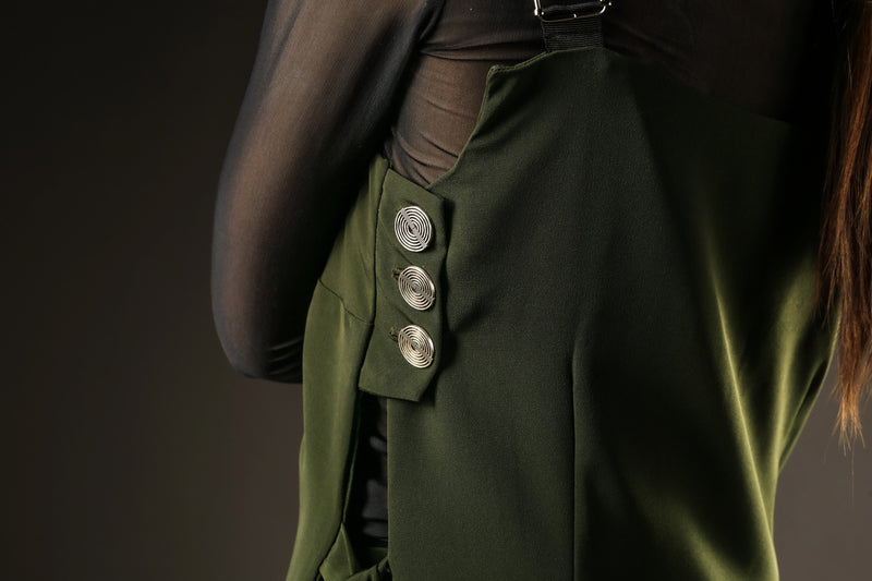 Button detail of the green pinafore dress Out of Sync