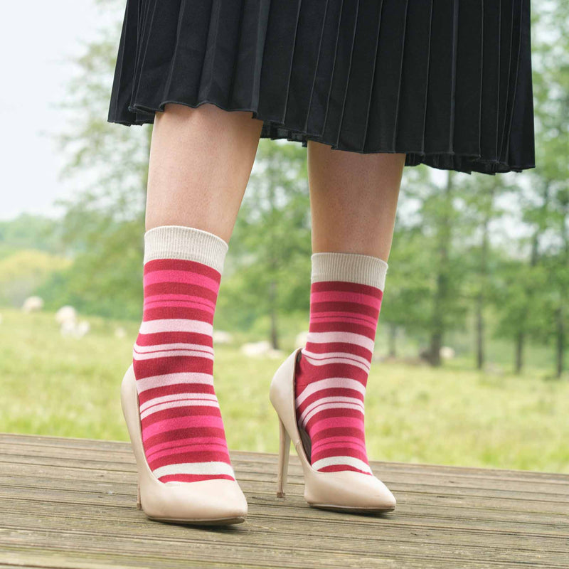 Woman wearing black skirt and Peper Harow's Elizabeth punch women's luxury socks